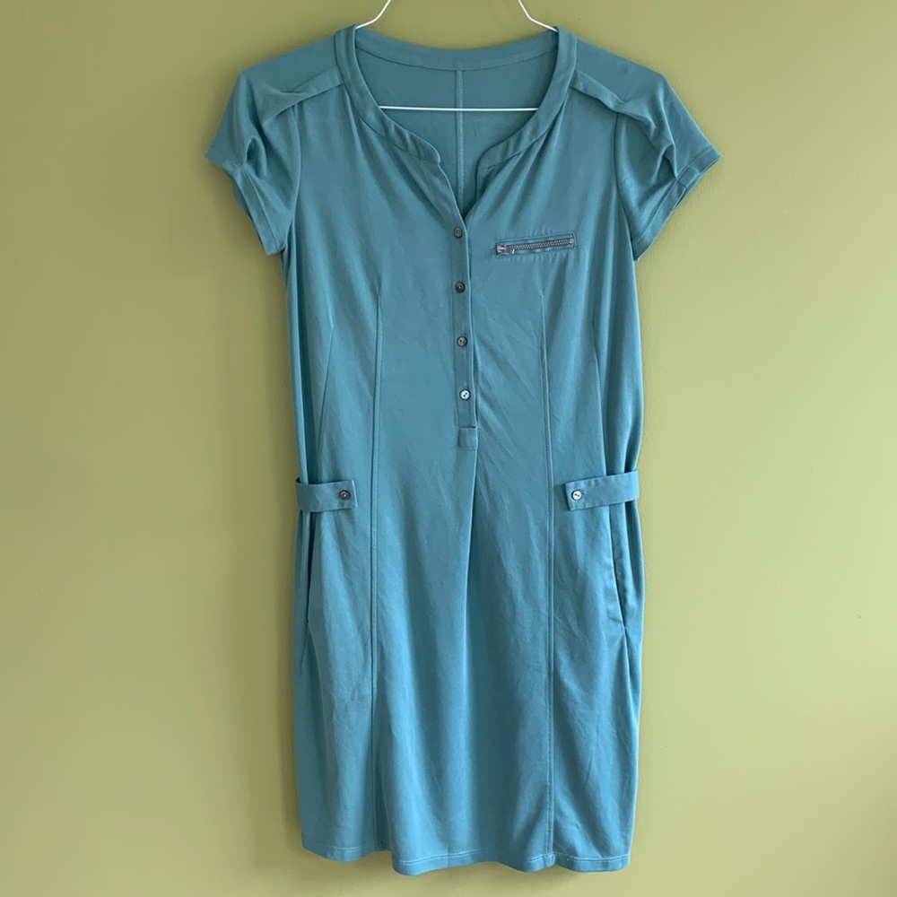 Sage green poly knit dress with pockets and elastic waist and zipper detail.